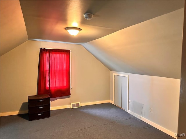 bonus room featuring lofted ceiling and carpet flooring