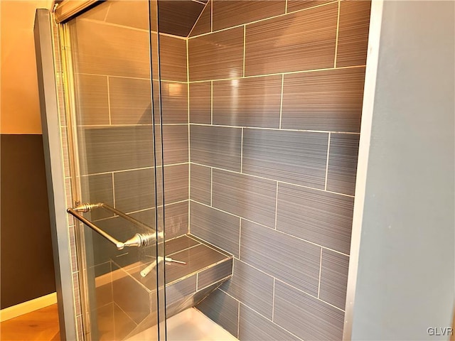 bathroom featuring a shower with shower door