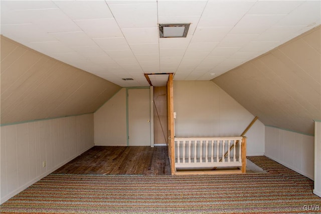 additional living space with lofted ceiling and dark hardwood / wood-style flooring