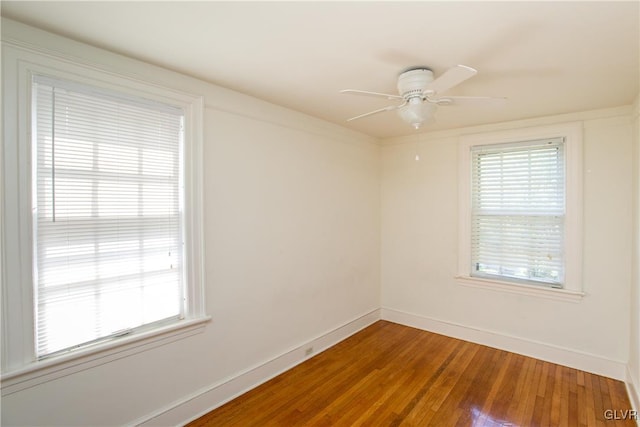 spare room featuring wood-type flooring and ceiling fan