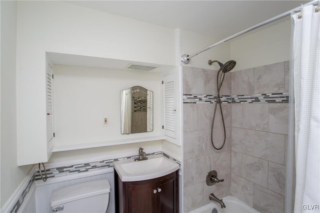 full bathroom featuring shower / bath combo, vanity, and toilet