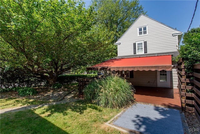 view of side of home with a yard