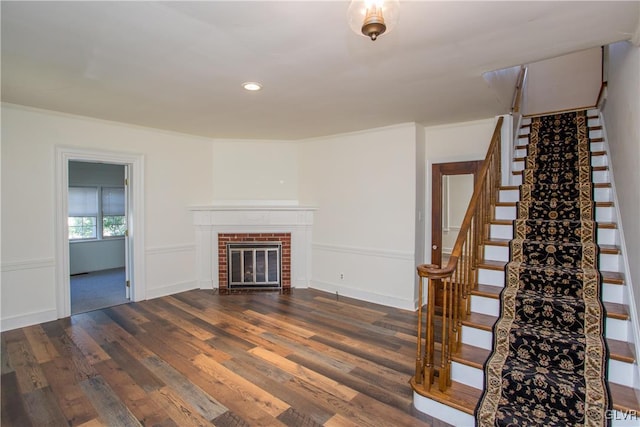 unfurnished living room featuring a fireplace and dark hardwood / wood-style floors