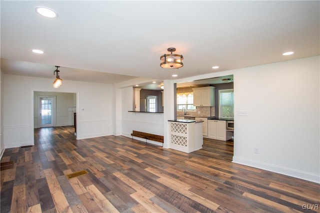 unfurnished living room featuring dark hardwood / wood-style flooring