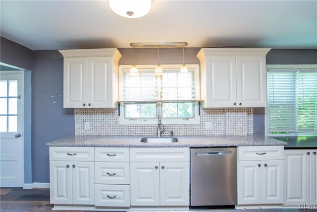 kitchen featuring sink, white cabinets, hanging light fixtures, and dishwasher