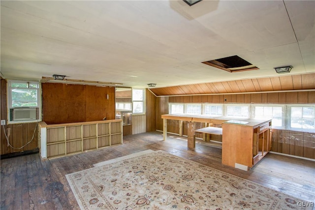 additional living space featuring cooling unit, hardwood / wood-style floors, and wood walls