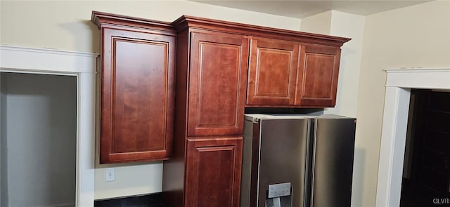 interior details featuring stainless steel refrigerator with ice dispenser