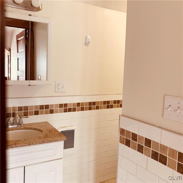 bathroom featuring tile walls and vanity