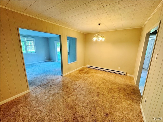 carpeted empty room with a notable chandelier, crown molding, a baseboard radiator, and wooden walls