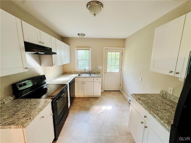 kitchen with light stone countertops, sink, white cabinets, and black appliances