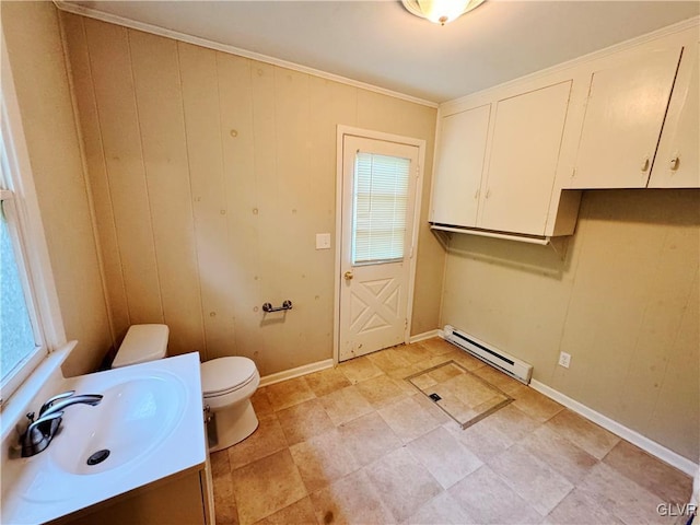 bathroom featuring vanity, a wealth of natural light, a baseboard radiator, and toilet