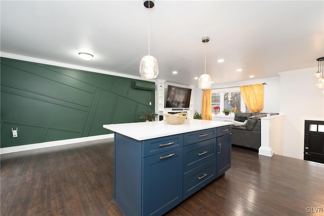 kitchen featuring crown molding, dark wood-type flooring, hanging light fixtures, a center island, and an AC wall unit