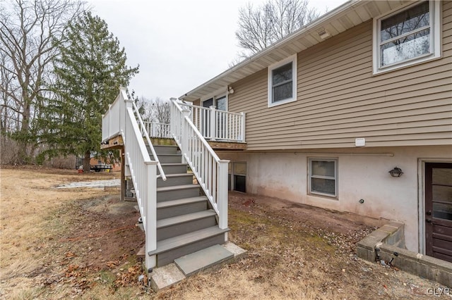 rear view of house featuring a wooden deck