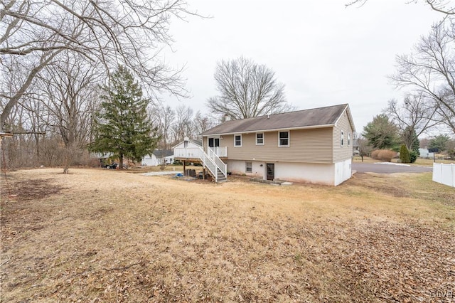 rear view of property with a lawn