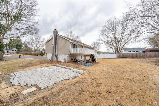 rear view of property with a patio area and a lawn