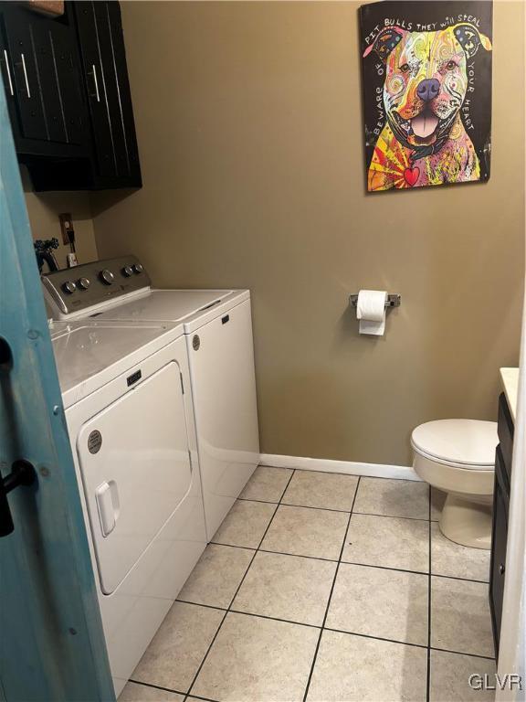 laundry room featuring light tile patterned flooring and washing machine and clothes dryer