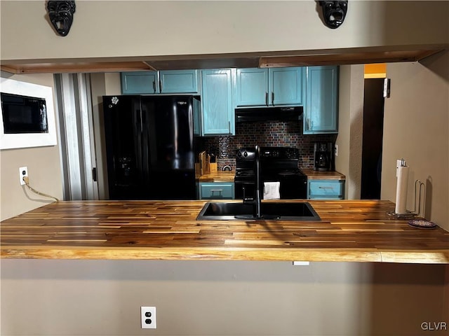 kitchen with blue cabinets, butcher block counters, sink, decorative backsplash, and black appliances