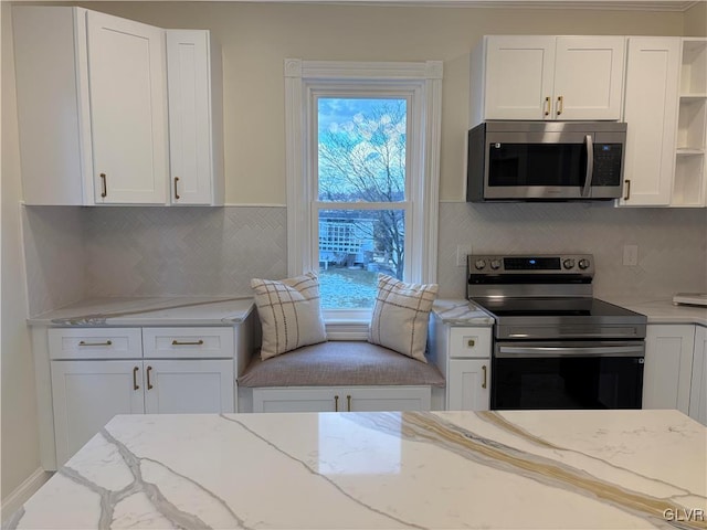 kitchen with appliances with stainless steel finishes and white cabinets