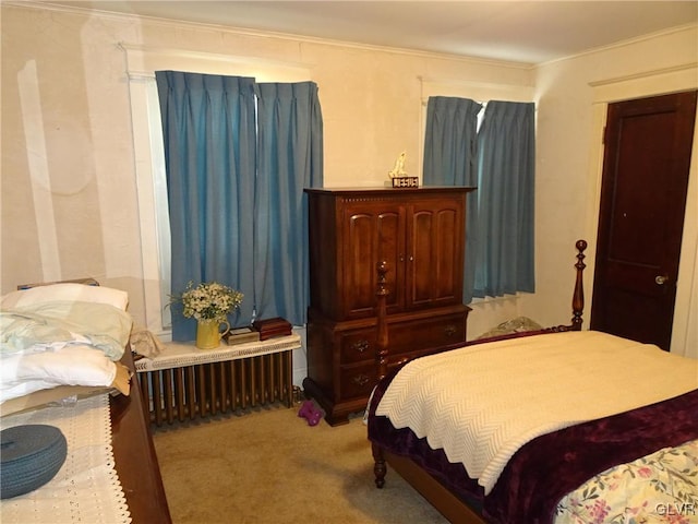 bedroom featuring ornamental molding, carpet floors, and radiator