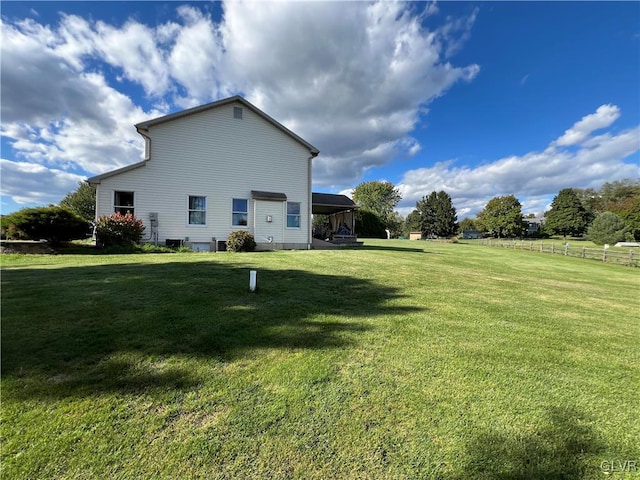 view of side of property featuring a yard