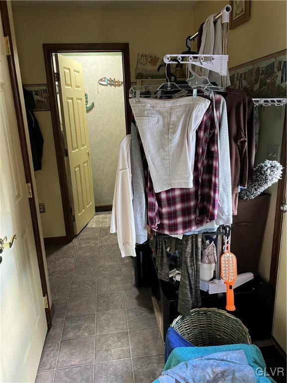 spacious closet with tile patterned floors