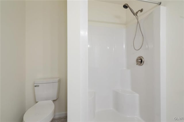 bathroom with toilet and walk in shower