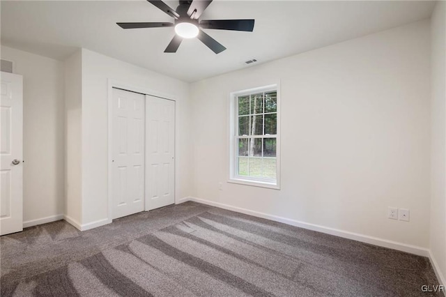 unfurnished bedroom featuring a closet, ceiling fan, and carpet