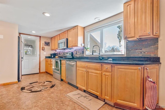 kitchen featuring sink, decorative backsplash, and stainless steel appliances