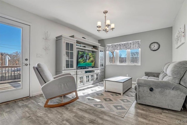 living room featuring hardwood / wood-style flooring and a chandelier