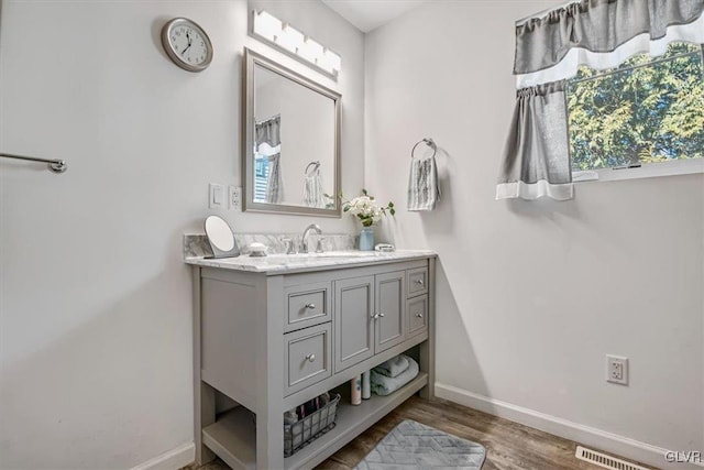 bathroom with vanity and hardwood / wood-style flooring