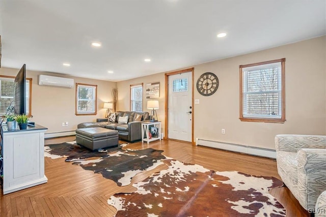 living room with hardwood / wood-style flooring, a baseboard radiator, and a wall mounted air conditioner