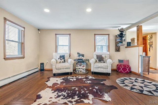 sitting room with hardwood / wood-style floors, plenty of natural light, and baseboard heating