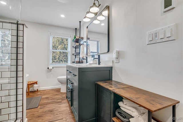 bathroom featuring vanity, hardwood / wood-style floors, and toilet