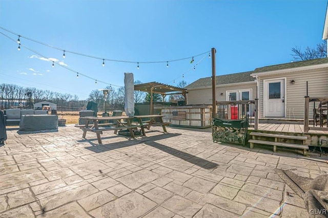 view of patio / terrace featuring a wooden deck, outdoor lounge area, and a pergola