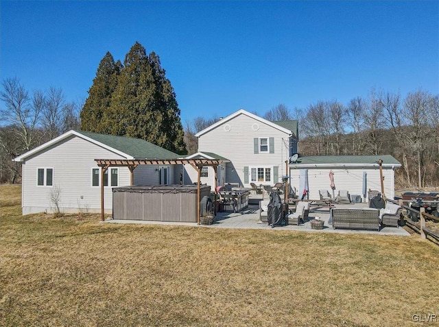 rear view of house featuring a lawn, a gazebo, an outdoor living space, a patio area, and a hot tub