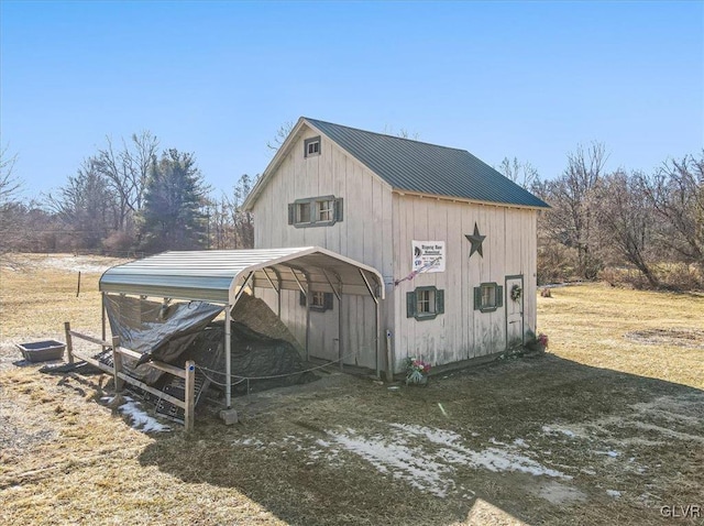 view of outdoor structure with a yard and a carport