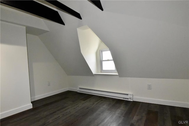 additional living space with lofted ceiling with beams, a baseboard heating unit, and dark wood-type flooring