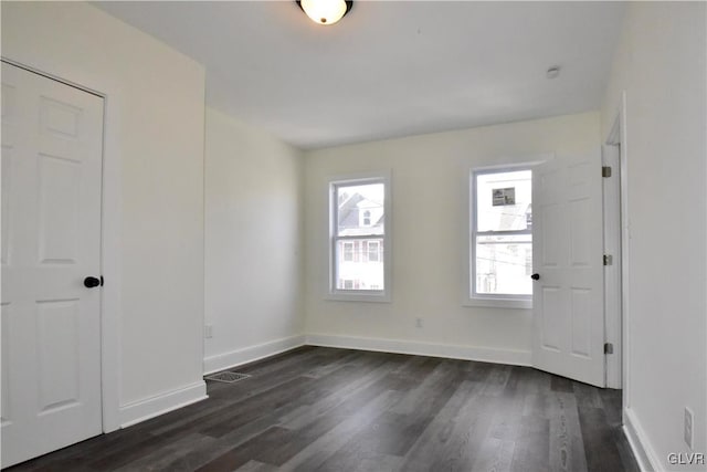 spare room with dark wood-type flooring