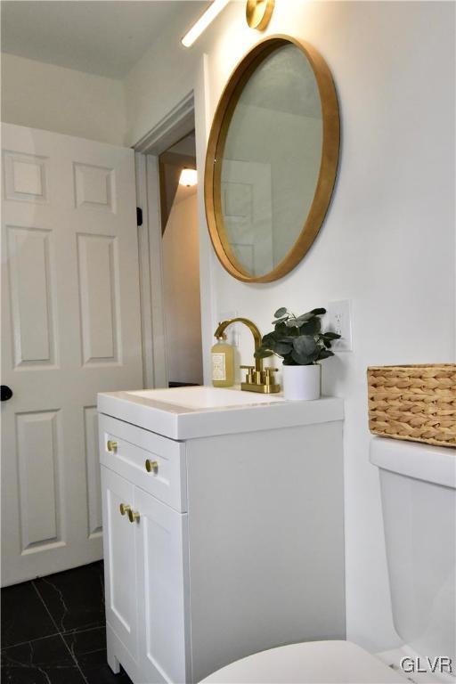 bathroom featuring vanity and toilet