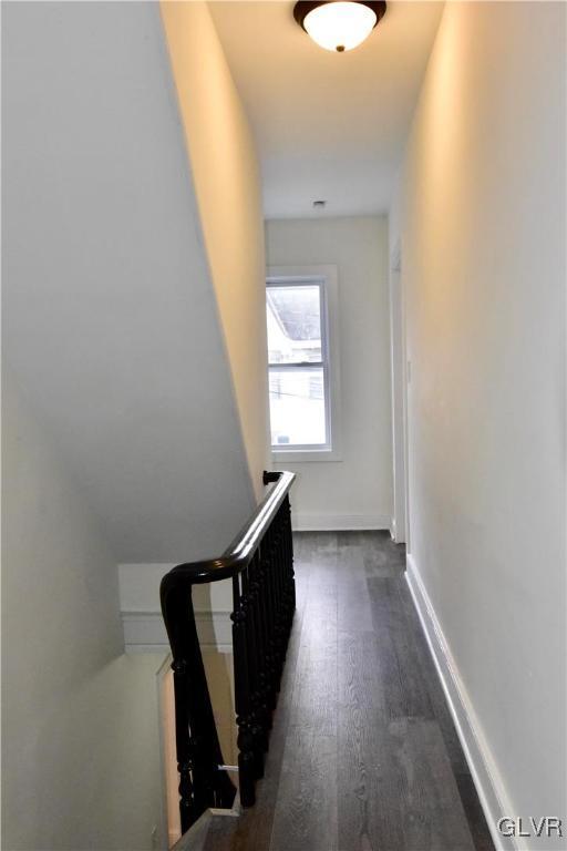 corridor featuring dark wood-type flooring