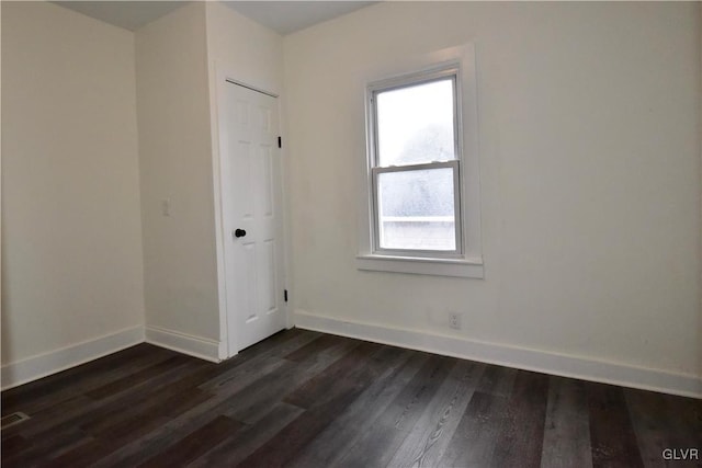 empty room with dark wood-type flooring