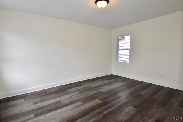 spare room with dark hardwood / wood-style flooring