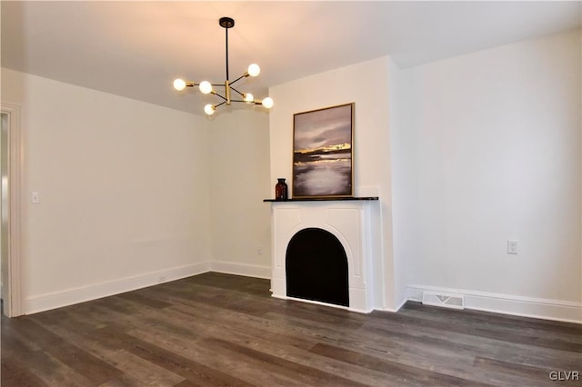 unfurnished living room featuring dark hardwood / wood-style floors and a chandelier