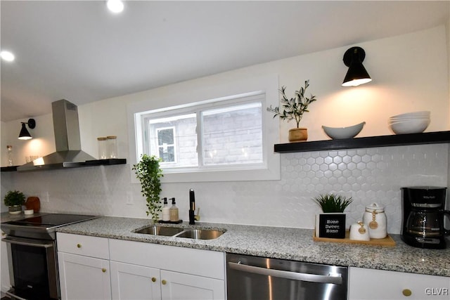 kitchen featuring sink, backsplash, stainless steel appliances, white cabinets, and wall chimney exhaust hood