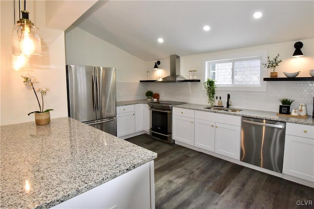 kitchen featuring appliances with stainless steel finishes, wall chimney exhaust hood, sink, and white cabinets