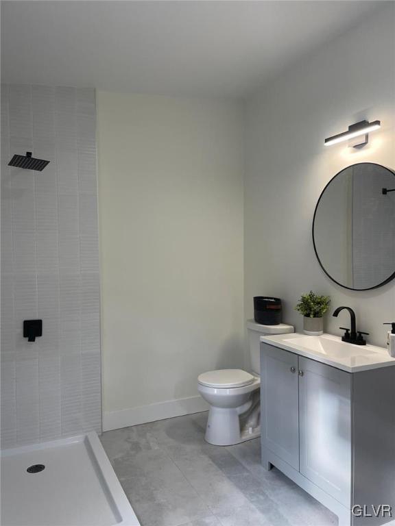 bathroom with vanity, a shower, and toilet