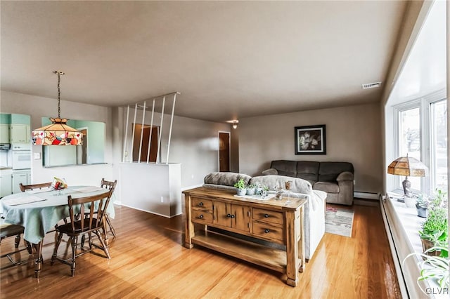 living room featuring hardwood / wood-style floors and a baseboard radiator