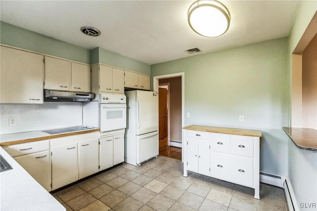 kitchen with white appliances, cream cabinetry, and baseboard heating