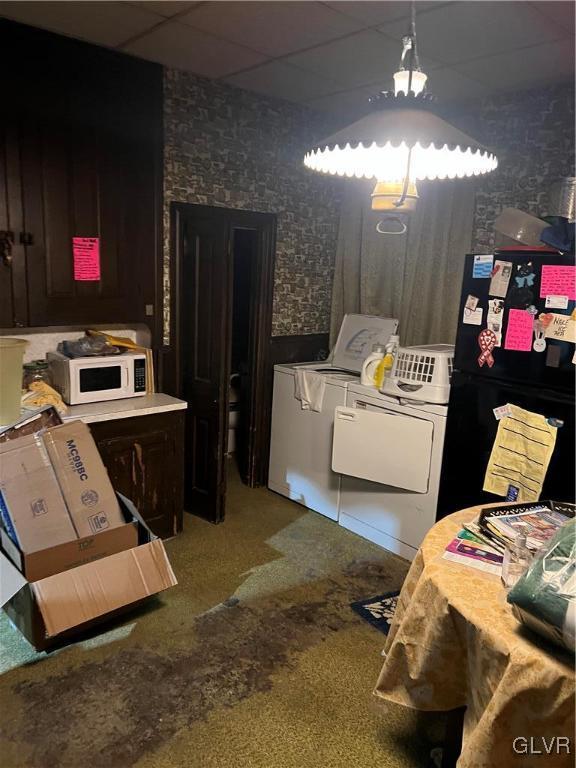 bathroom with a paneled ceiling and washing machine and clothes dryer