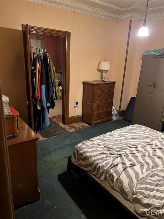 bedroom featuring ornamental molding and a closet